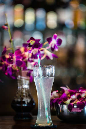 Composition with margarita cocktail and orchid flowers on the blurred backgroundの写真素材
