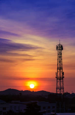 Silhouette signal antenna tower at beautiful sunset sky backgroundの写真素材