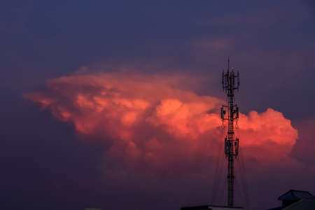 Silhouette signal antenna tower at beautiful sunset sky backgroundの写真素材