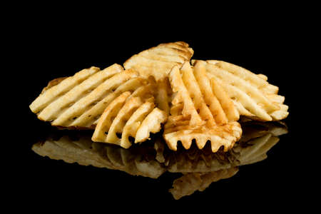 Pile of Potato Fries with reflection isolated on black background