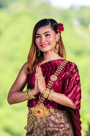 Beautiful Woman with Thai Traditional Dress King Rama 1 posing in ruined buildingの写真素材