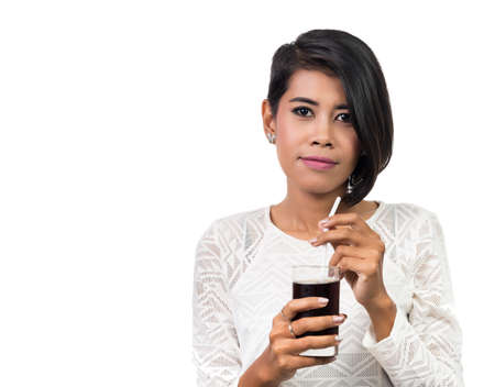 Beautiful asian woman holding glass of cola,  isolated on white background