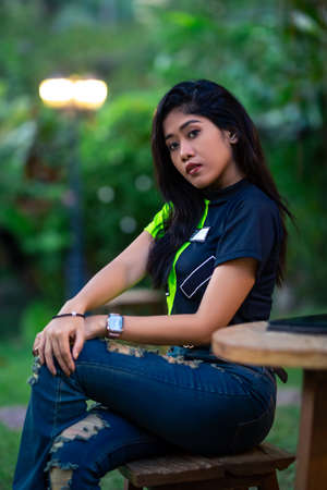 Close-Up portrait of young asian woman posing at the table in cafe. Tablet computer