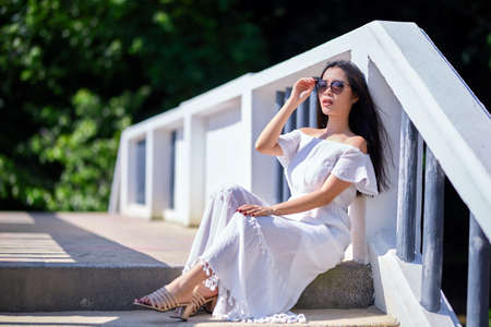 Close-Up Portrait Of Beautiful Asian Girl  in the white dressの写真素材