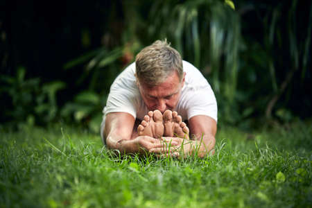 A man practice yoga in the green tropical jungleの写真素材