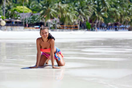 Sexy girl in red swimsuit enjoying at the tropical beach in Thailandの写真素材