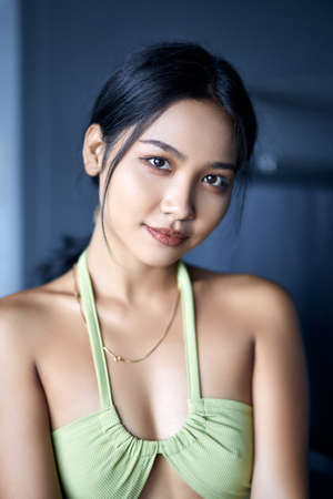 Indoor close-up fashion portrait of young beautiful Asian woman