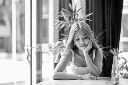 Close-Up portrait of young asian woman with long hair posing at the table in cafeの写真素材