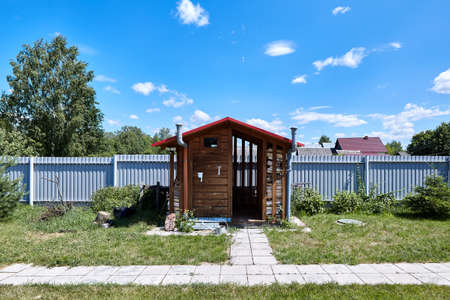 Old rural wooden house in russian village at summer sunny day