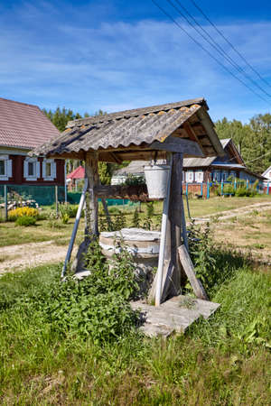 Traditional Russian old water well in the village. Rural landscapeの写真素材