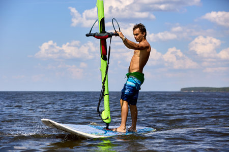 Side view of a windsurfer passing byの写真素材