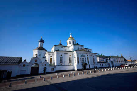 Historic Epiphany Church with green domes at Nikolaevsky Arzamas Monastery on Cathedral Square, Arzamas, under a clear blue skyの写真素材