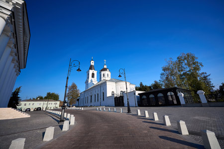 White church with bell towers and a central dome on Cathedral Square in Arzamas, under a clear blue sky, showcasing serene religious architectureの写真素材