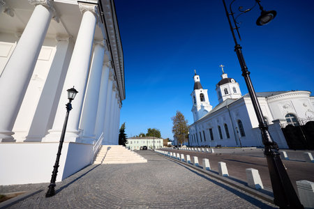 White church with bell towers and a central dome on Cathedral Square in Arzamas, under a clear blue sky, showcasing serene religious architectureの写真素材