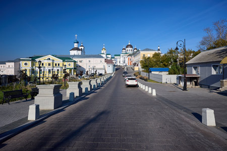 A serene street view leading to Majestic Resurrection Cathedral an elegant church with striking...
