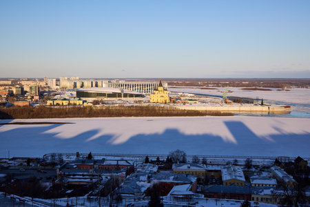 A breathtaking winter panorama of Strelka in Nizhny Novgorod, where the Oka River meets the Volga. Featuring the Alexander Nevsky Cathedral under clear blue skiesの写真素材