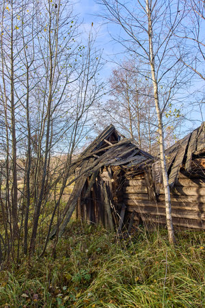 Discover the haunting beauty of an old, abandoned Russian bathhouse, slowly crumbling amidst a stunning autumn landscape. A poignant reminder of forgotten times and nature's reclamationの写真素材