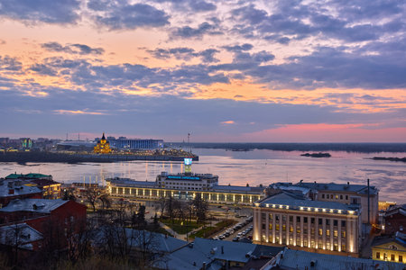 A stunning twilight scene over Strelka in Nizhny Novgorod, with the Oka River reflecting the lights of Alexander Nevsky Cathedral under a pastel skyの写真素材