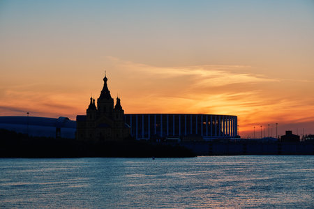 Scenic sunset over Strelka with silhouettes of Alexander Nevsky Cathedral and Nizhny Novgorod Stadiumの写真素材