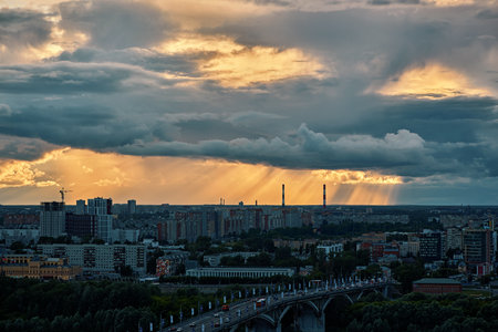 A stunning sunset Over Kanavinsky Bridge and Oka River in Nizhny Novgorod, casting golden rays through cloudsの写真素材