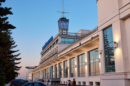 Nizhny Novgorod River Station shines at evening, with its modern facade illuminated against a twilight sky, bustling with people and scenic charmの写真素材