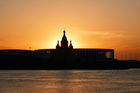 Scenic sunset over Strelka with silhouettes of Alexander Nevsky Cathedral and Nizhny Novgorod Stadiumの写真素材