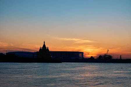 Scenic sunset over Strelka with silhouettes of Alexander Nevsky Cathedral and Nizhny Novgorod Stadiumの写真素材