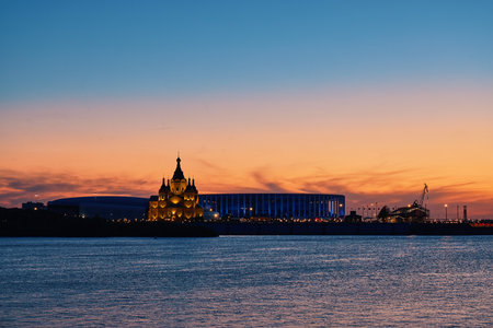 Evening view of illuminated Alexander Nevsky Cathedral and Nizhny Novgorod Stadium at dusk with vibrant sunset skyの写真素材