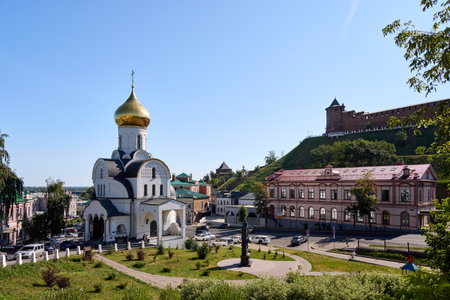 Morning shot of Kazan Church in Nizhny Novgorod with its golden dome glowing under early sunlight,...
