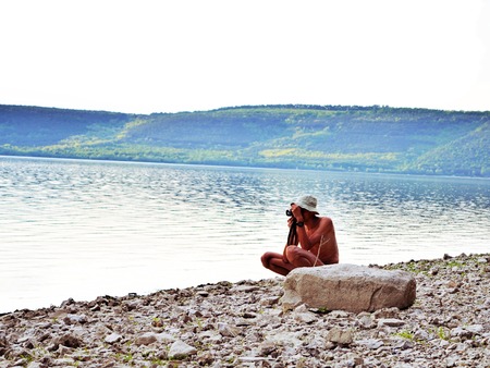 Professional nature photographer taking photos by the river sideの写真素材