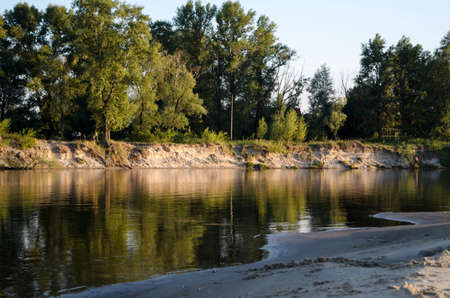 Picturesque shore sloping sand bank of the river in Ukraineの写真素材