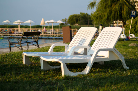 Two white chairs at the  beach in the summer. Travel concept