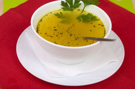 a plate of hot soup with greensの写真素材