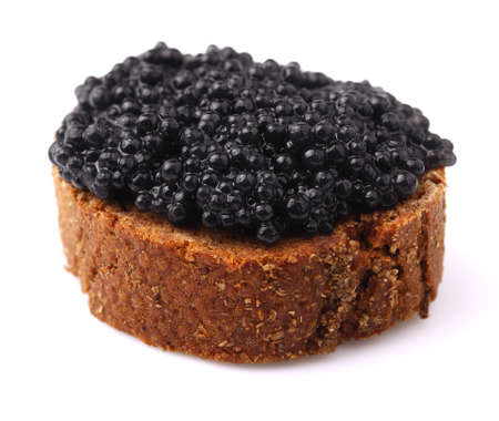 Rye bread with black caviar on white.の写真素材