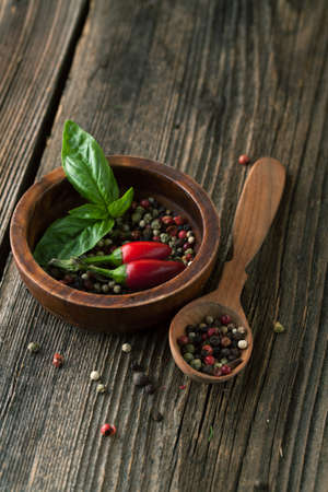 Basil and pepper mix on the wooden spoonの写真素材