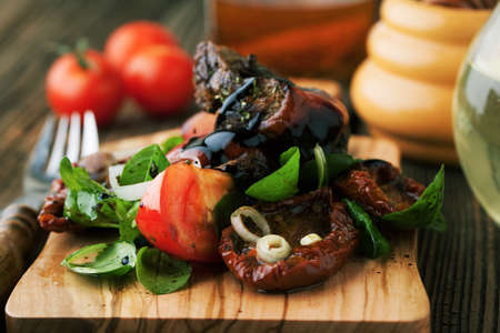 Salad with beef meat and vegetables on a wooden backgroundの写真素材