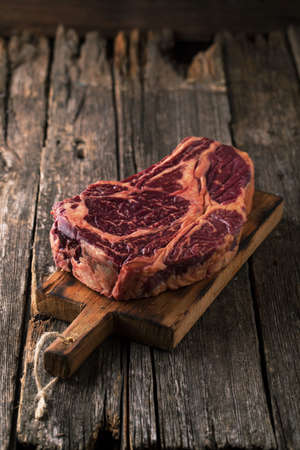 Raw fresh meat Ribeye Steak on wooden backgroundの写真素材