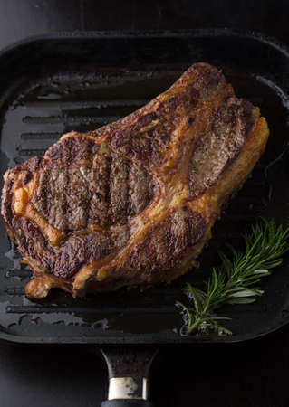 Grilled Black Angus Steak Ribeye  with rosemary, spice and salt on a dark backgroundの写真素材