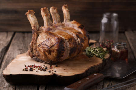 Grilled pork chop with spices, rosemary on a wooden backgroundの写真素材