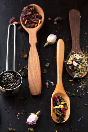 Assortment of tea with a spoon on a dark backgroundの写真素材
