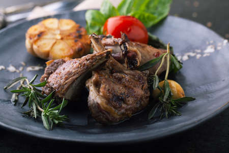 Roasted rack of lamb with vegetables, garlic and rosemary.の写真素材