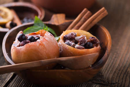 Baked apples with nuts and honey on wooden backgroundの写真素材