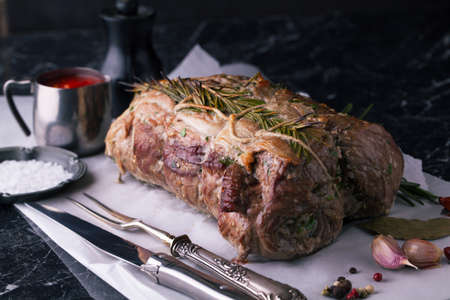 Beef roulade with smoked bacon and rosemary on a dark backgroundの写真素材