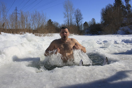TOMSK, RUSSIA - MARCH 7: Traditional Siberian winter recreation - swimming in the ice-hole, March 7, 2009 in Tomsk, Russia.のeditorial素材