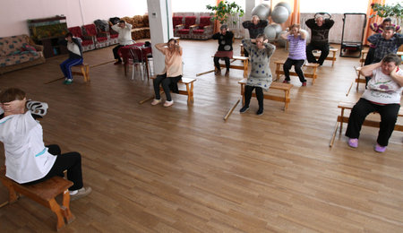 PODPOROZHYE, RUSSIA - MARCH 11: Day of Health in Center of social services for pensioners and the disabled Otrada (gymnastics with sticks for eldery), March 11, 2010 in Podporozhye, Russia.のeditorial素材