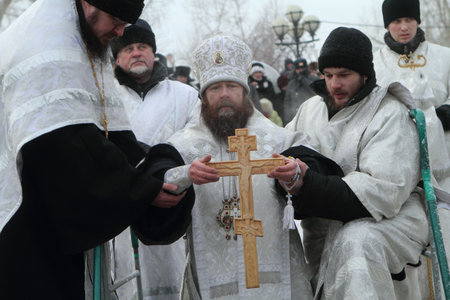 TOMSK, RUSSIA - JANUARY 19: Consecration ice-hole, Rostislav - Archbishop of Tomsk and Asino, commits the ceremony ritual, celebration of Epiphany (Holy Baptism), January 19, 2010 in Tomsk, Russia.のeditorial素材