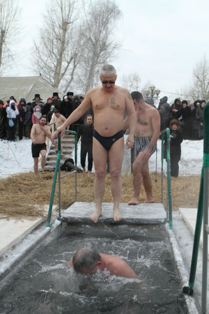 TOMSK, RUSSIA - JANUARY 19: Swimming in the ice-hole, celebration of Epiphany (Holy Baptism) in the Orthodox tradition, January 19, 2010 in Tomsk, Russia.のeditorial素材