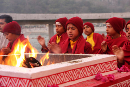 RISHIKESH, INDIA - JANUARY 19: Hindu students from the Parmath Niketan Ashram hold ceremonial lanterns during the daily aarti prayer on the River Ganges, January 19, 2009 in Rishikesh, India.のeditorial素材