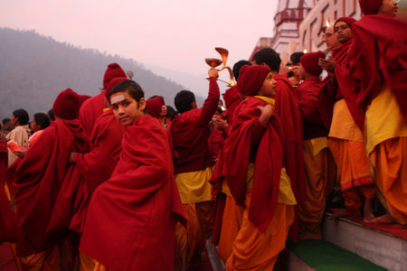 RISHIKESH, INDIA - JANUARY 19: Hindu students from the Parmath Niketan Ashram hold ceremonial lanterns during the daily aarti prayer on the River Ganges, January 19, 2009 in Rishikesh, India.のeditorial素材