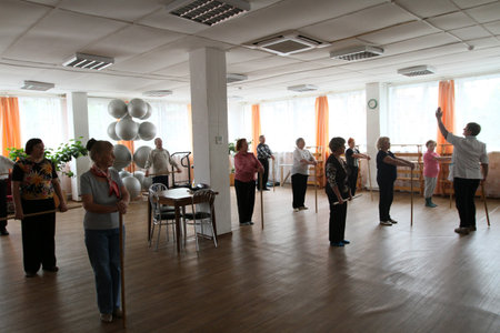 PODPOROZHYE, RUSSIA - JUNE 4: Day of Health in Center of social services for pensioners and the disabled Otrada (gymnastics with sticks for elders), June 4, 2010 in Podporozhye, Russia.のeditorial素材